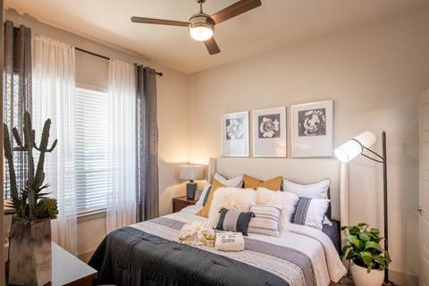 Cozy Bedroom Featuring Plush Bedding and Ceiling Fan