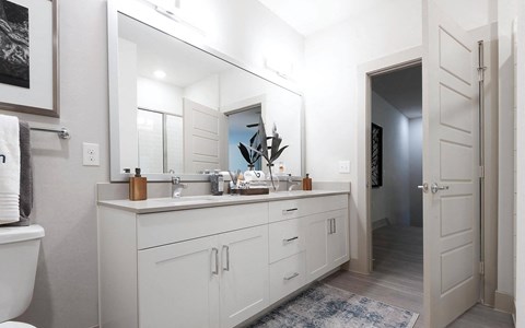 Modern Bathroom Featuring Double Vanity and Glass-Enclosed Shower