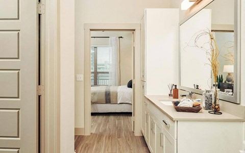Spacious Ensuite Bathroom with Large Mirror and Modern Cabinetry