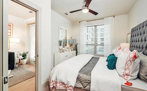 Spacious Bedroom Featuring Ceiling Fan and Natural Light