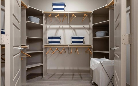 Oversized Walk-In Closet with Custom Built-In Shelving and Hanging Rods