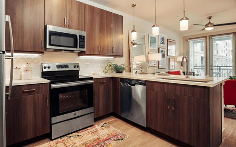 Contemporary Kitchen Featuring Quartz Countertops and Dark Cabinetry