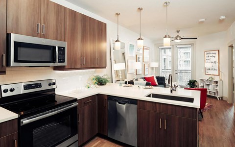 Open-Concept Layout with Kitchen, Living Area, and Access to Patio