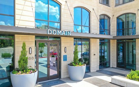 Leasing Office Entry at Domain at The Gate with Arched Windows and Modern Planters