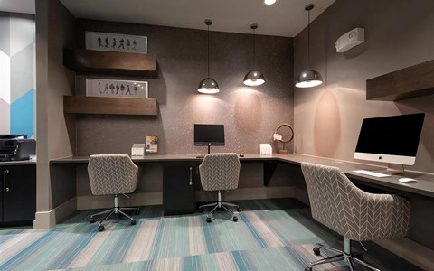 Business Center at Domain at The Gate Featuring Workstations and Modern Lighting