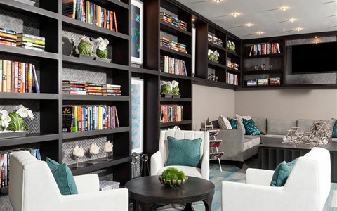 Lounge with Floor-to-Ceiling Library Shelves and Modern Seating