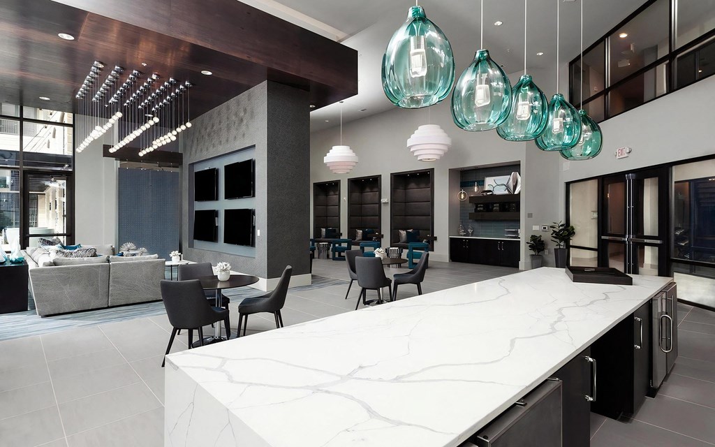 a large kitchen and dining room with a marble counter top