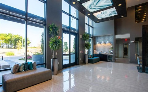 Spacious Main Entryway Featuring Large Windows and Guest Seating Area