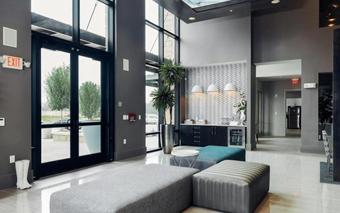 Modern Lobby with Coffee Bar, Patterned Wall Tile, and Lounge Seating