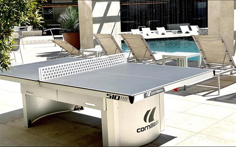 Table Tennis Setup in Courtyard Overlooking Resort-Style Pool
