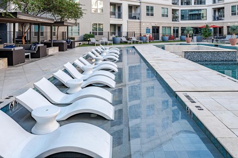 Stylish Poolside Sundeck Featuring Lounge Chairs and Community Seating