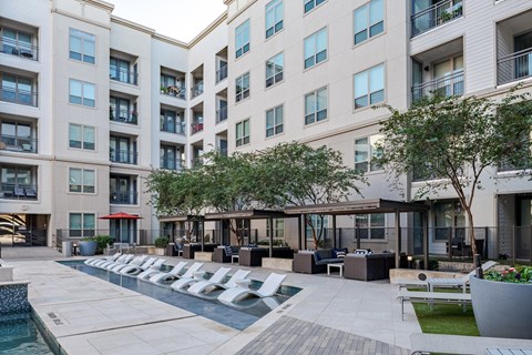 Outdoor Courtyard Featuring Shaded Seating and Stylish Poolside Vibe