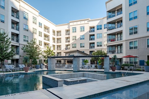 Resort-Style Pool with Water Features and Private Courtyard Seating