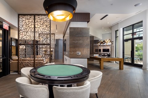 A modern dining room with a glass table surrounded by chairs.