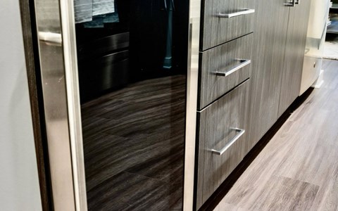 a modern kitchen with wood flooring and stainless steel cabinets