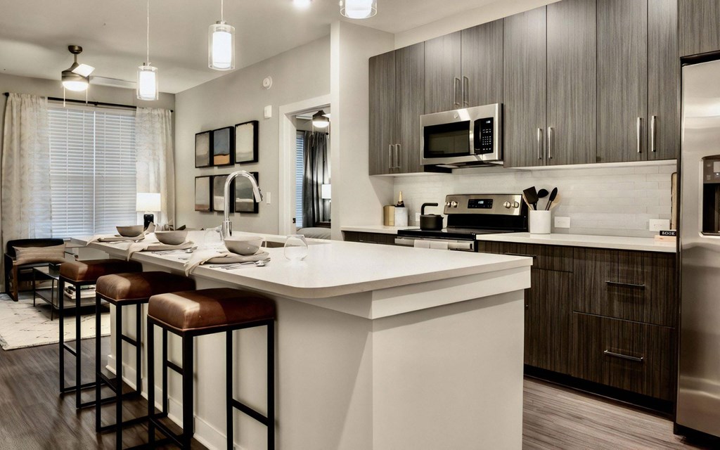 Kitchen with Island Seating, Dining Area, and Stainless Steel Appliances