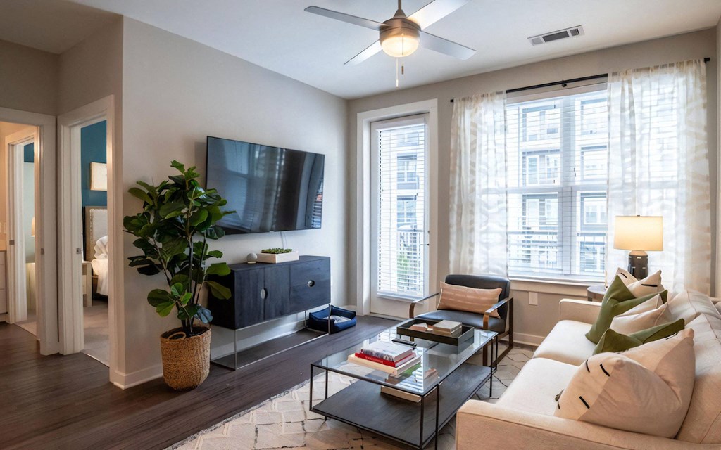 Apartment Interior Featuring Couch, Coffee Table, and Wall-Mounted TV
