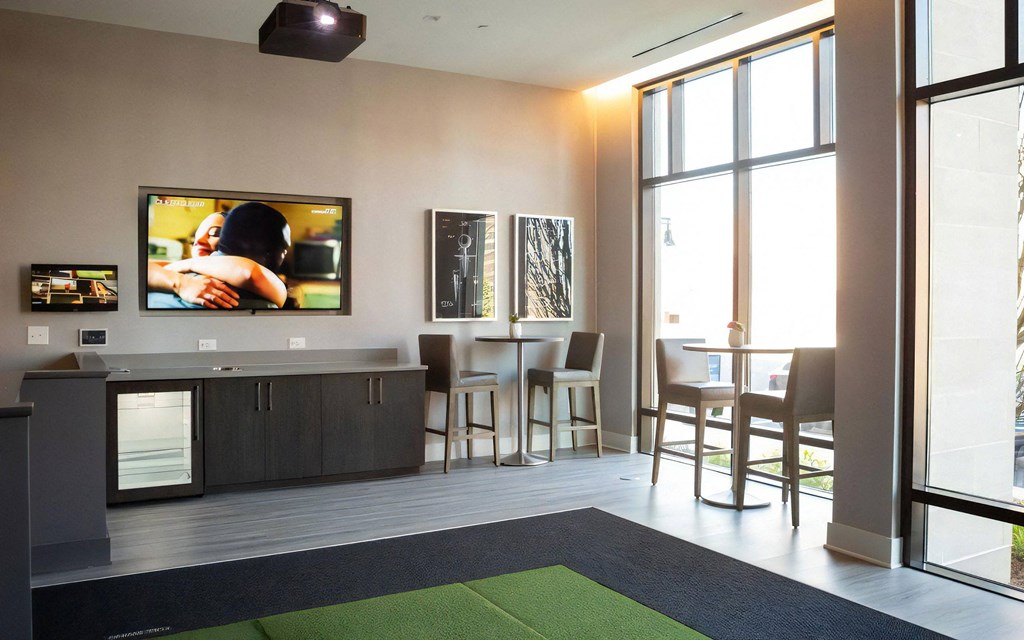 Lobby Area with High-Top Tables, Seating, and Wall-Mounted TV