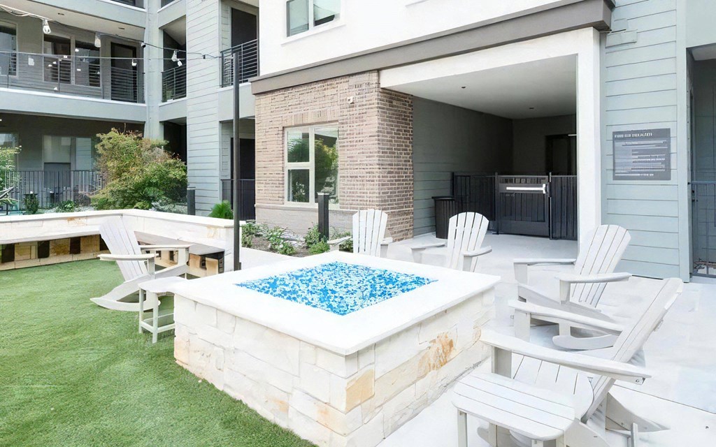 an outdoor patio with a pool and chairs around it