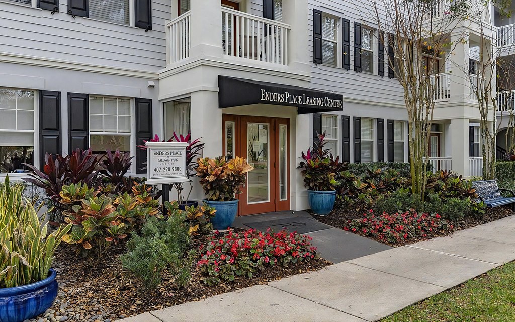 Inviting Leasing Office Entry at Enders Place at Baldwin Park with Colorful Flower Beds