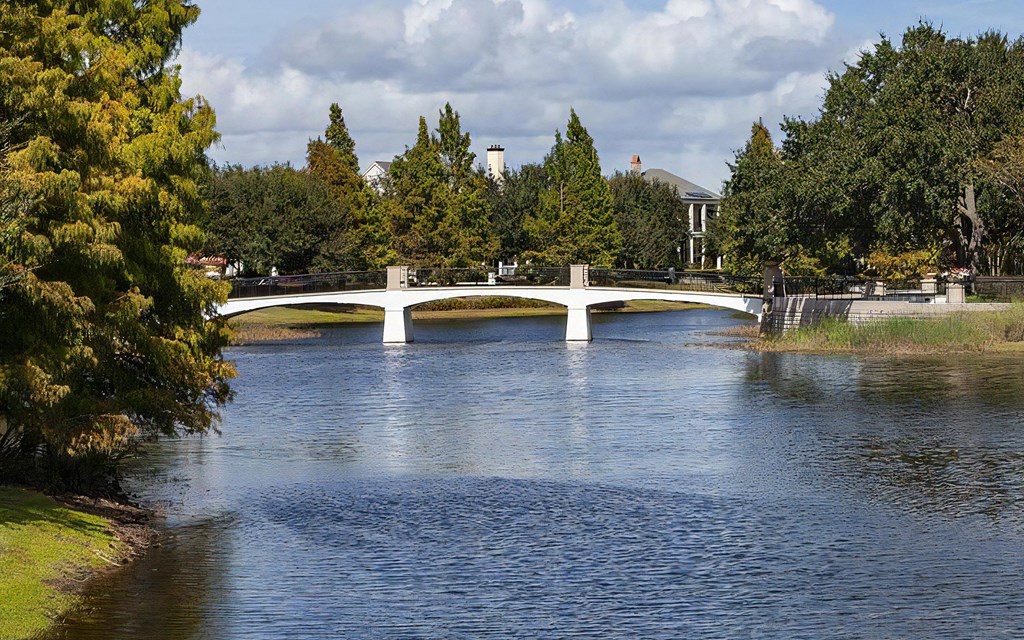 Scenic Community Bridge Crossing Over Calm Waterway with Park Access