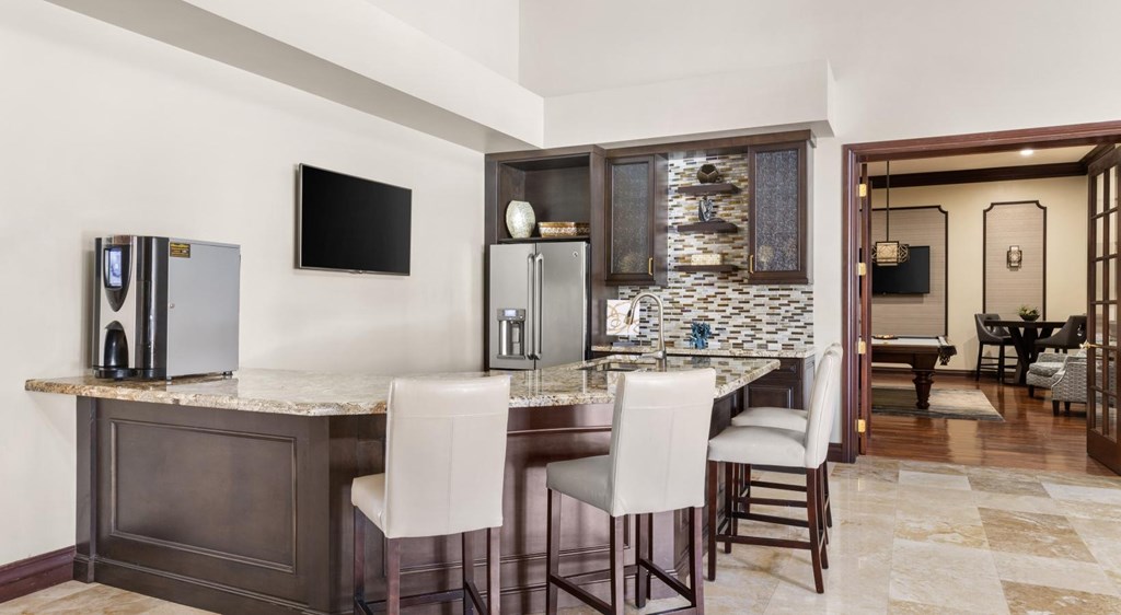 A kitchen with a bar area and a dining table.