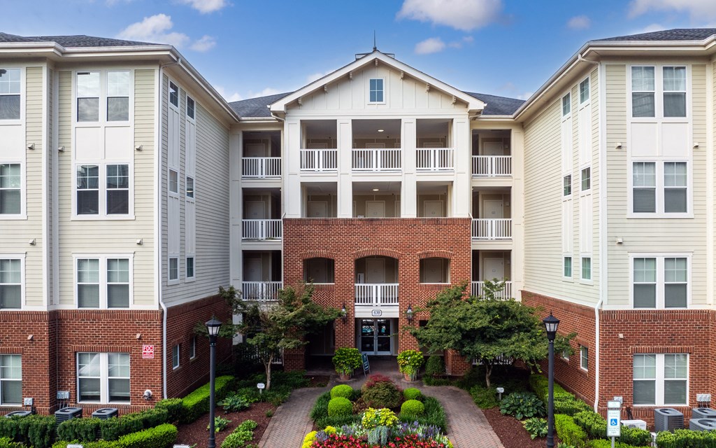 Allister North Hills Main Building Entrance Surrounded by Lush Gardens and Elegant Architecture