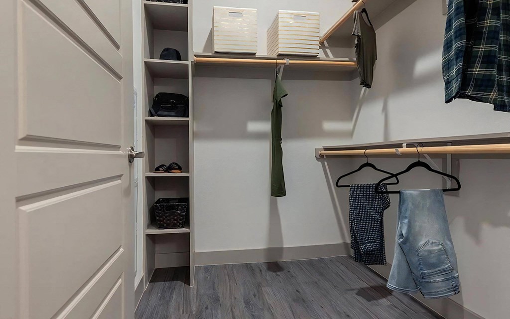 Spacious Walk-In Closet with Built-In Shelving and Ample Hanging Space