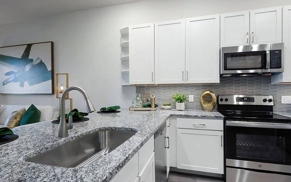 Kitchen with Granite Countertops, Stainless Steel Appliances, and Stylish Backsplash