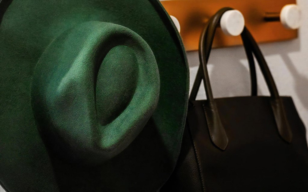 Wall-Mounted Hooks with Stylish Green Hat and Black Tote