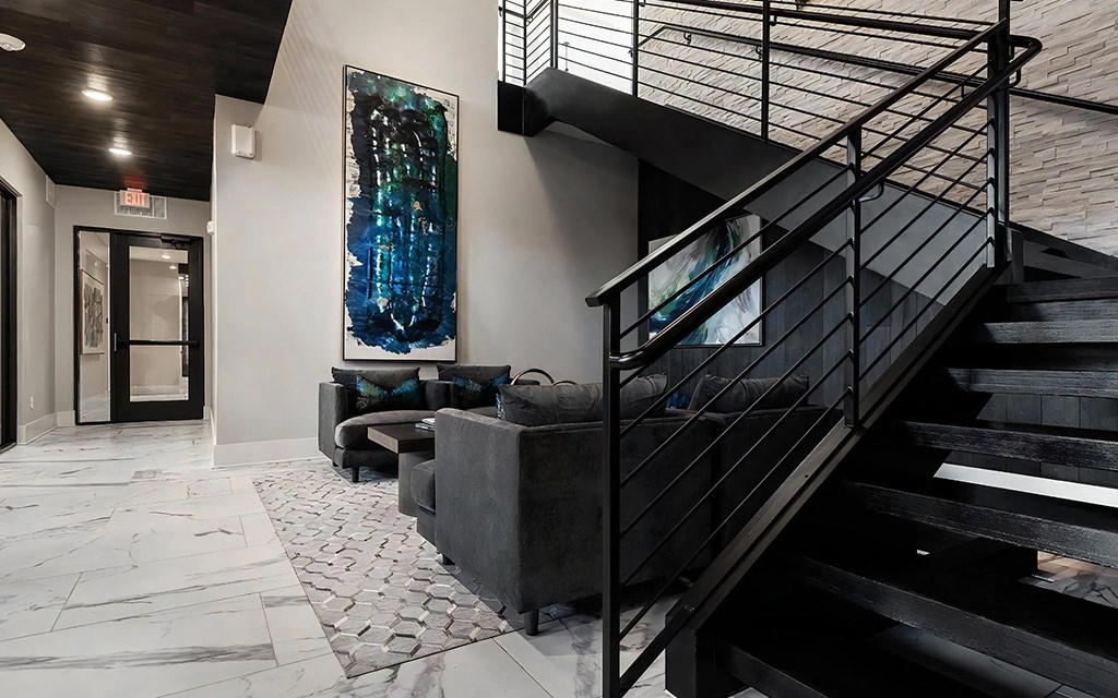 Contemporary Lobby with Black Staircase and Cozy Seating Area