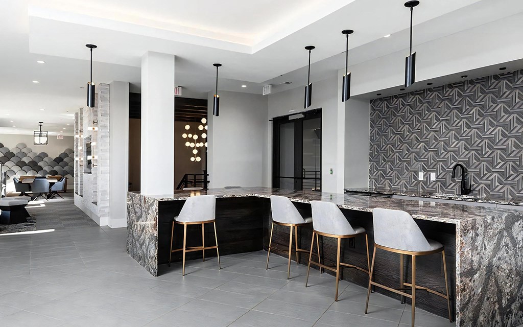 Multi-Use Community Lounge with Game Tables and Bar Area