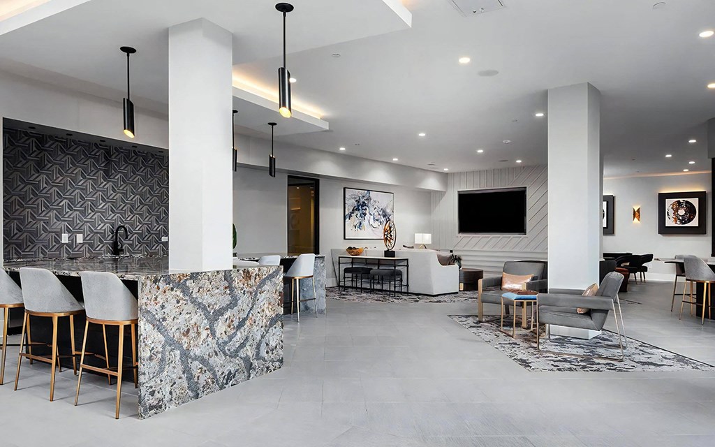 Multi-Use Community Lounge with Game Tables and Bar Area