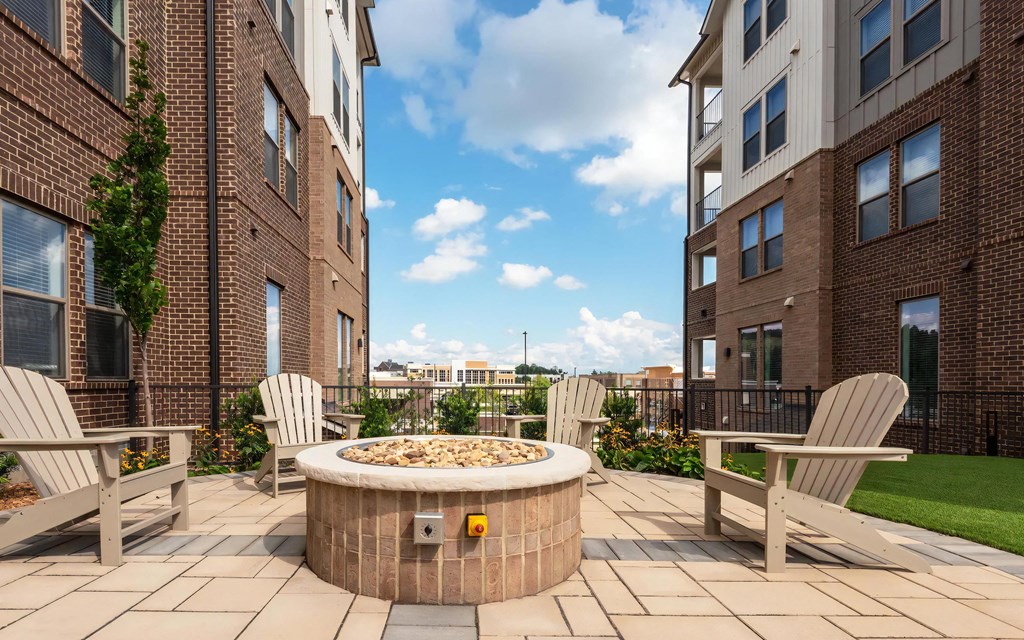 Outdoor Social Space with Fire Pit and Seating Between Apartment Buildings