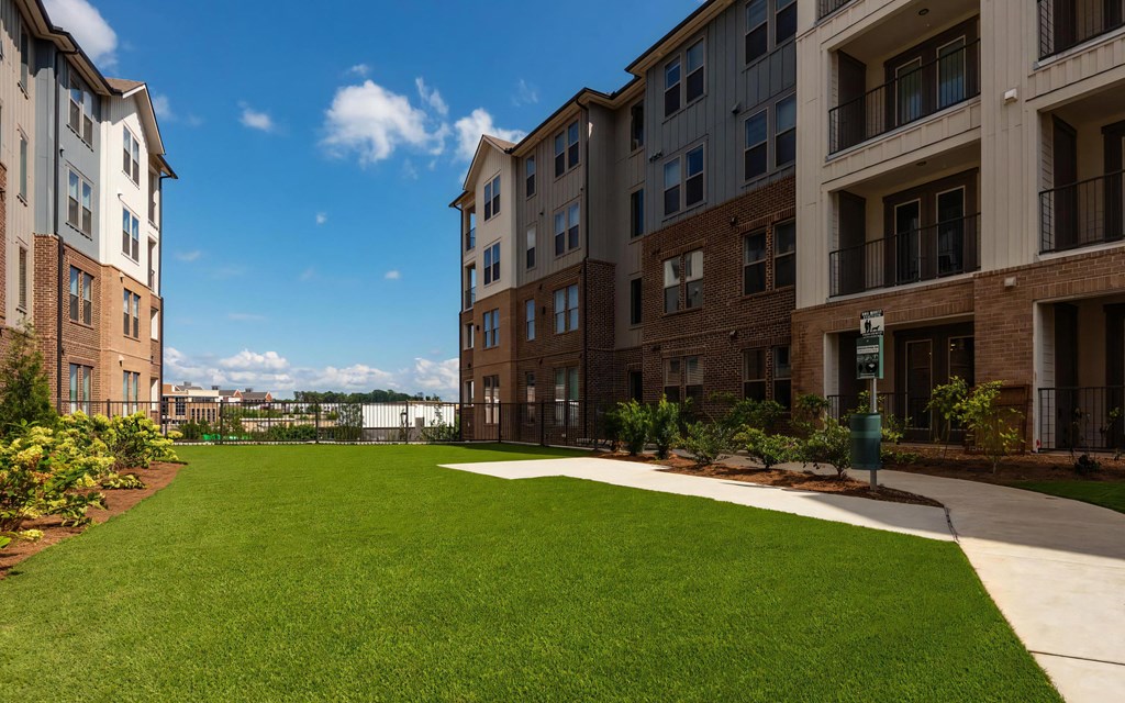 Pet-Friendly Grass Courtyard with Sidewalk and Dog Amenities