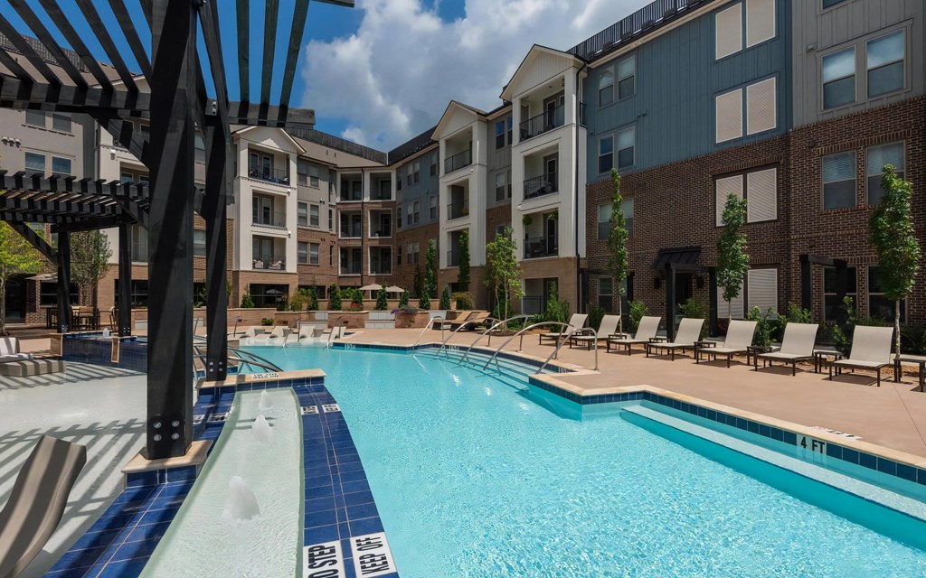 Community Pool Area Featuring Lounge Deck and In-Pool Sun Shelf