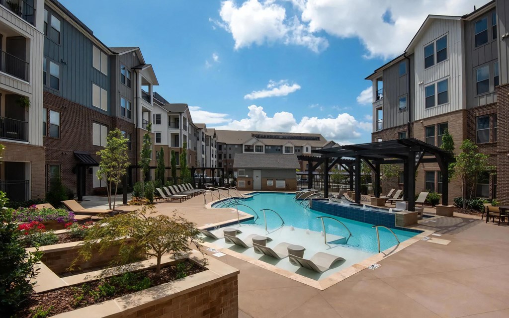 Courtyard Pool Area with Landscaping and Ample Lounge Chairs