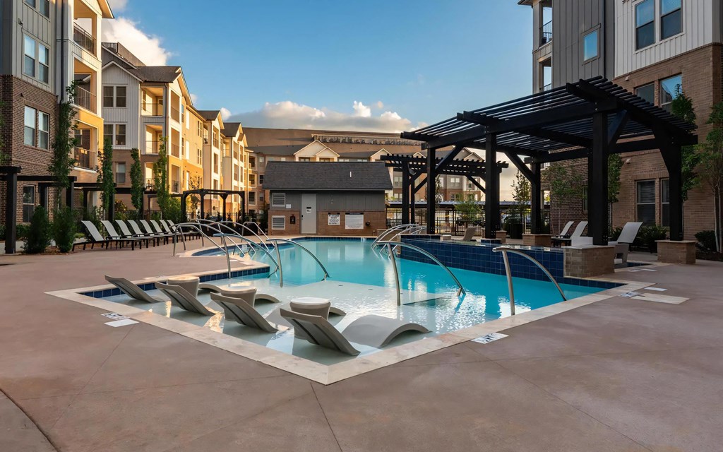 Relaxing Poolside Ambiance with Built-In Lounge Chairs at Dusk