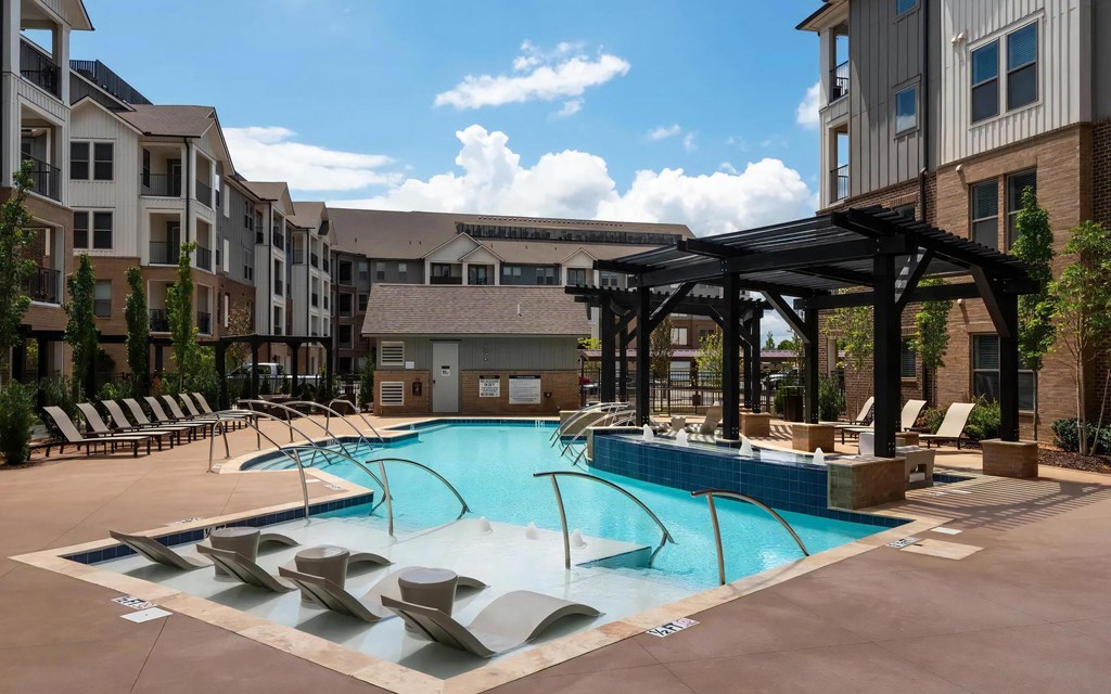 Sleek Poolside Escape with Umbrella Loungers and Water Jets
