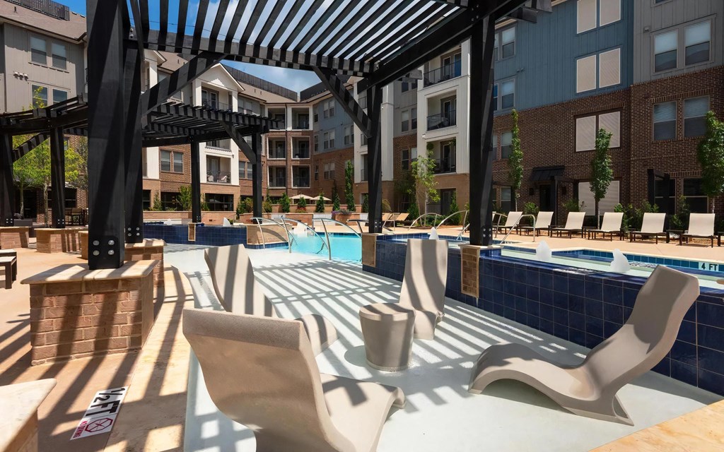Poolside Pergola with In-Water Loungers and Modern Seating