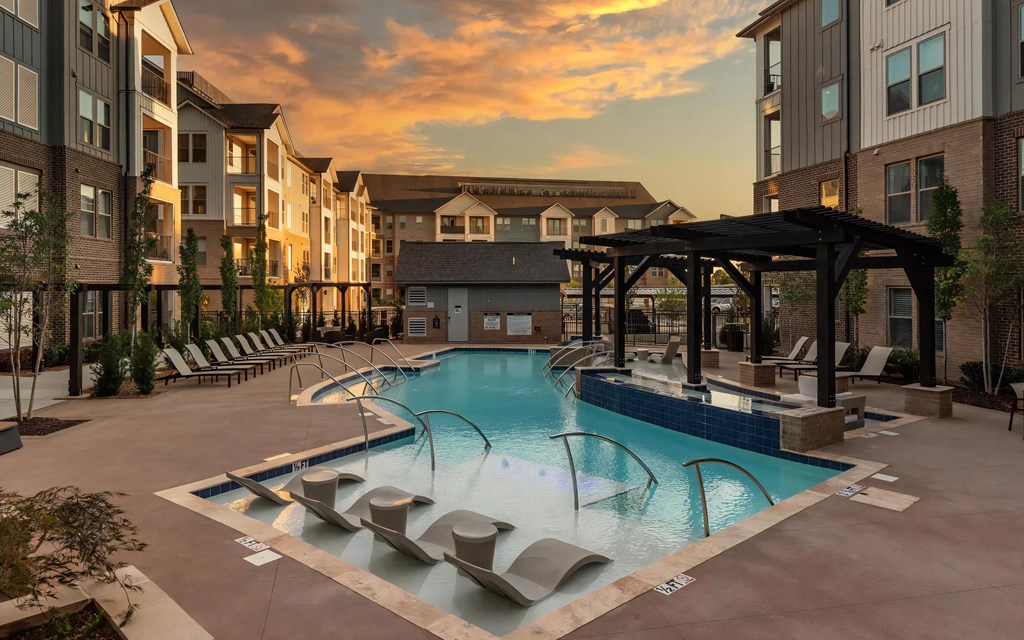 Modern Pool Surrounded by Lounge Chairs and Pergola Seating