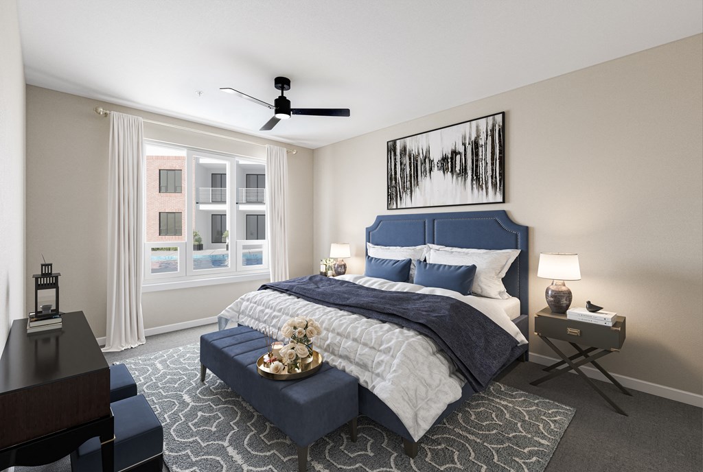 a bedroom with a blue and white bed and a ceiling fan