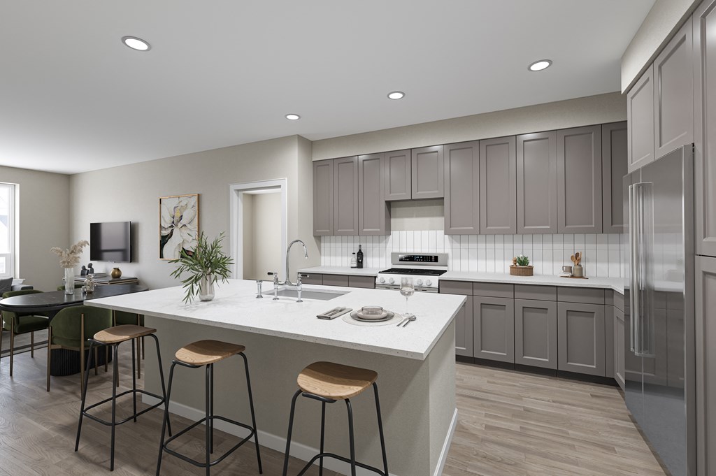 Modern Kitchen with Light Gray Cabinetry, White Quartz Countertops, and Island Bar Seating