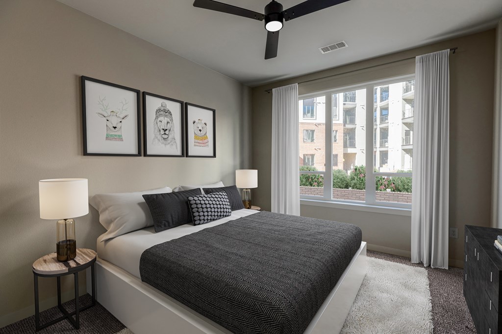 a bedroom with a bed and a large window