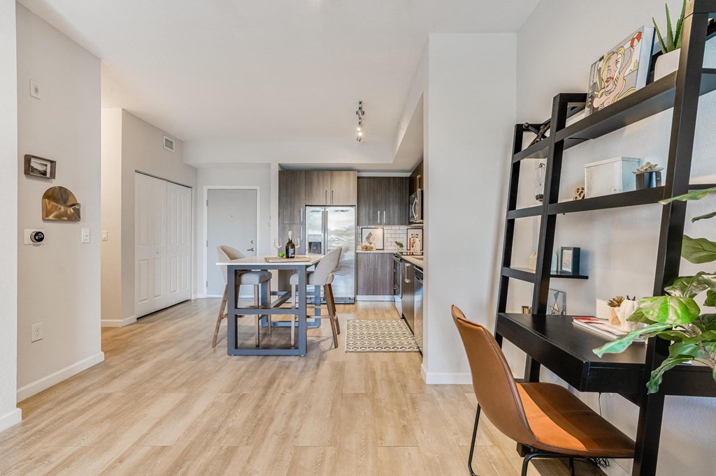 Kitchen Island with Seating and Open Wall Shelving Workspace Nearby