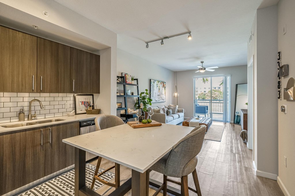 Island with Seating and Full Kitchen Facing Sofa and Sliding Doors