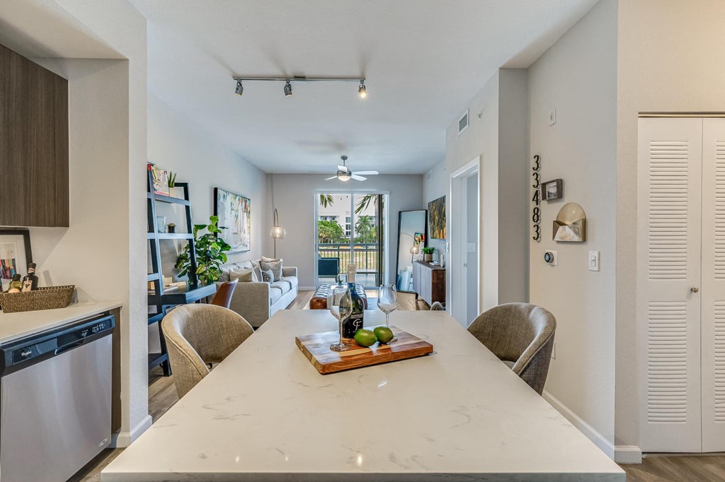 Kitchen Island with Wine Setup and View of Living Room and Balcony