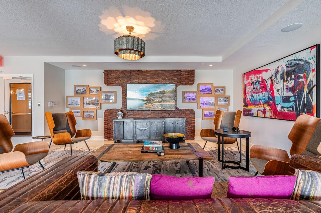 Clubroom Lounge Area with Leather Sofas, Framed Art, and Mounted TV
