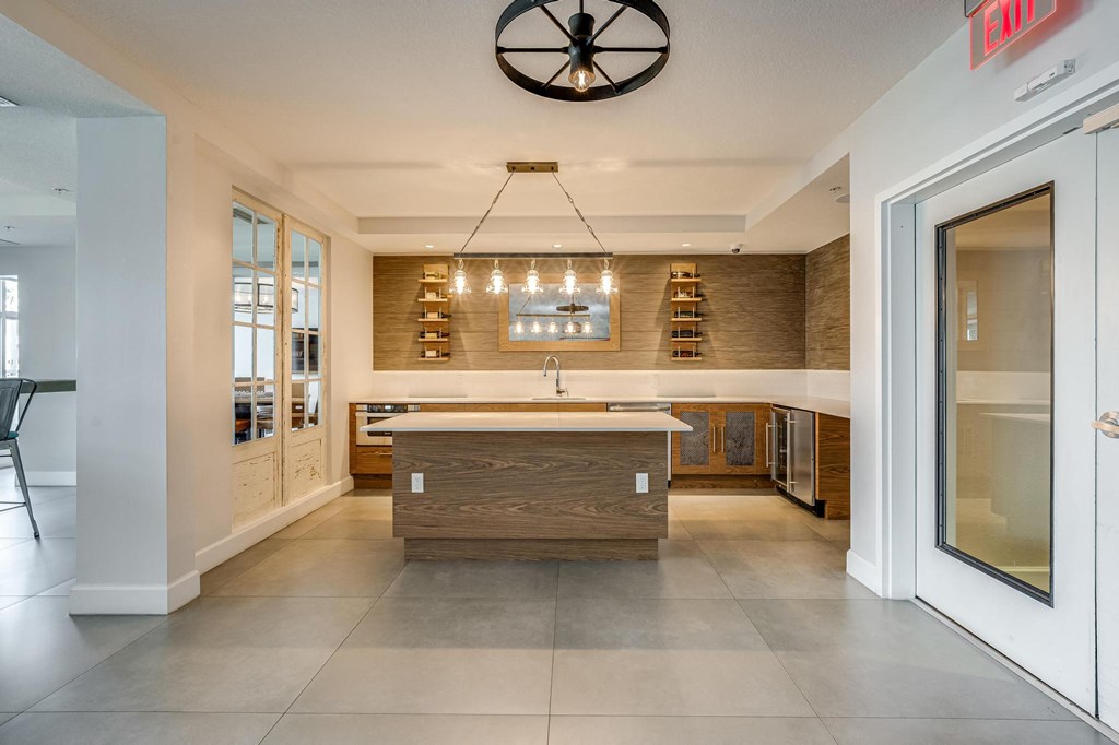 Open Kitchenette with Wall Shelving, Island Counter, and Wine Fridge