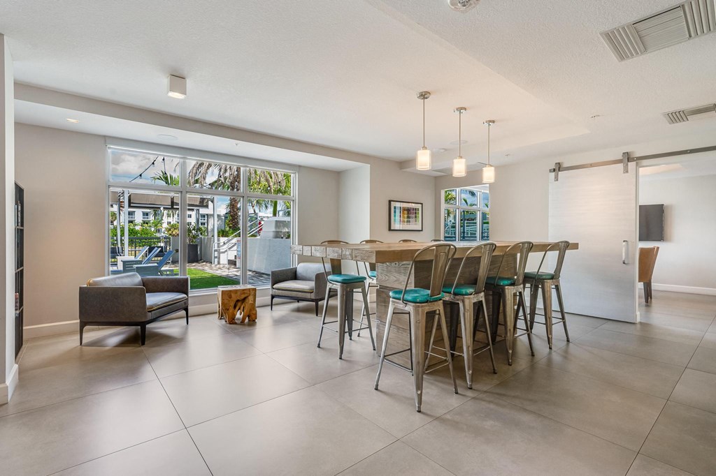 Clubhouse Community Room with Long Table and Outdoor Access
